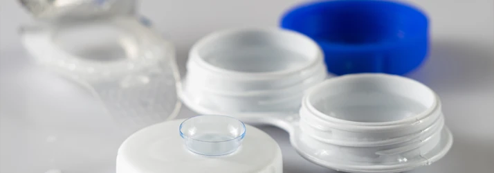 Contact lens case with open compartments and a soft contact lens placed on top