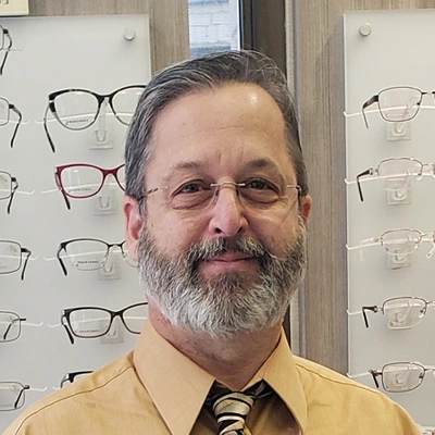 Person wearing glasses standing in an eyewear store